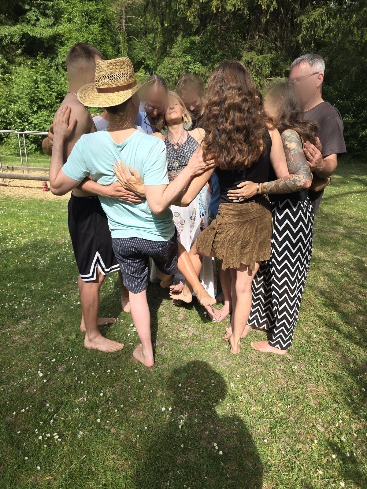 Gruppe in einer achtsamen Umarmung beim Kuschel-Picknick am Kuhsee (Gesichter anonymisiert)